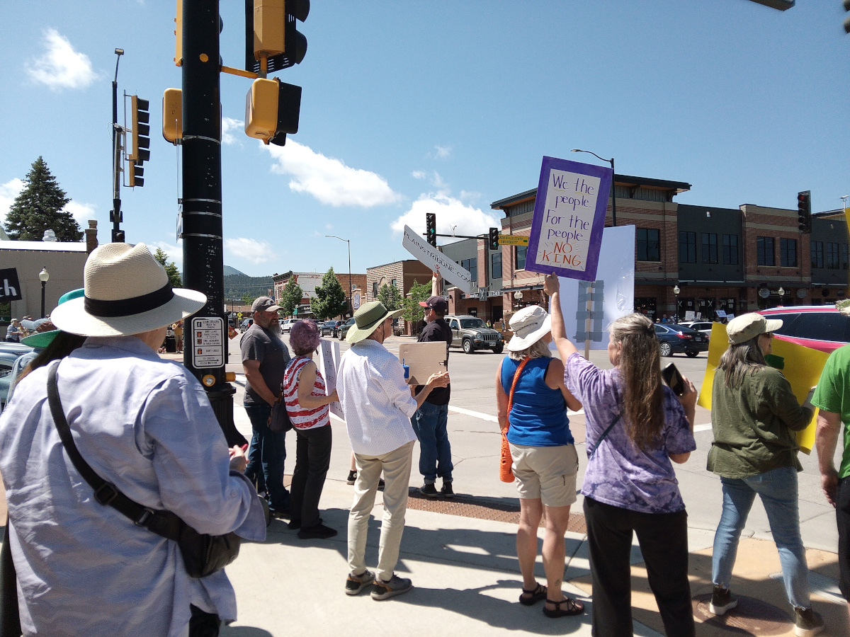 photo of people with signs at the Spearfish No Kings Event